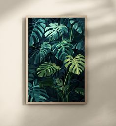 a green leafy wall hanging above a bed