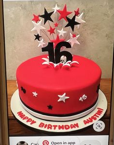 a red birthday cake with white stars and the number fifteen on it's top