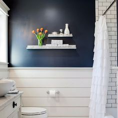 a white toilet sitting next to a sink in a bathroom