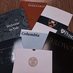 four different colored folders sitting on top of a wooden table