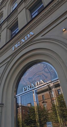 the entrance to prada is reflected in the windows