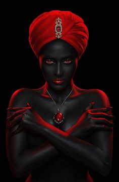 a woman with black skin and red hair wearing a turban