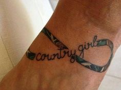 a woman's foot with the word country on it and an army ribbon around her ankle