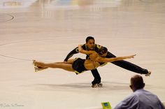 two people are performing an artistic dance on the floor