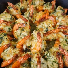 cooked shrimp with herbs and cheese in a skillet