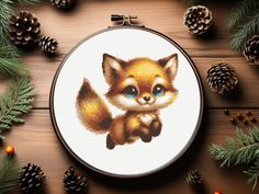 a cross stitch fox with blue eyes sitting next to pine cones