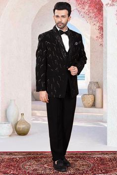 This Sherwani is expertly crafted with cutdana embroidery, adding a touch of vibrant elegance to a classic black design. Made for any special occasion, this piece will elevate your formal wear with its intricate details. Perfect for those looking for a sophisticated and unique look. Black Party Wear Tuxedo For Evening, Black Tuxedo For Evening Party Wear, Black Tuxedo For Evening Party, Black Fitted Bandhgala For Semi-formal Occasions, Black Party Wear Suits For Evening, Designer Festive Unstitched Suit For Semi-formal Occasions, Black Bandhgala With Long Sleeves For Party Wear, Black Evening Party Wear Suits, Black Sets For Evening Eid Celebration