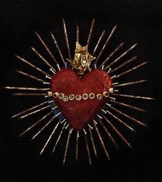 a red heart surrounded by gold spikes