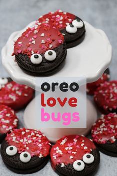 red and white decorated cookies on a cake plate with googly eyes in the middle