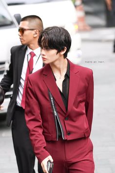 a man in a red suit walking down the street