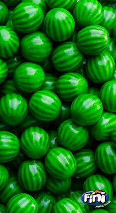 green candy balls are stacked on top of each other