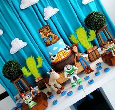 toy story themed birthday party with toys on the table and decorations in front of them