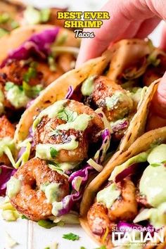 some tacos with shrimp and guacamole on them