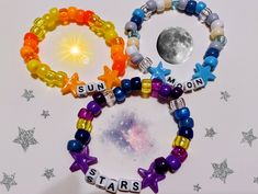 three bracelets that say sun, stars and moon on them with beads in the shape of letters