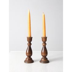 two wooden candlesticks sitting side by side