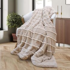 a large blanket sitting on top of a wooden floor