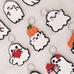 several embroidered key chains with chicken and carrots on them