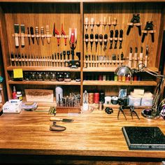 a workbench filled with lots of crafting supplies and tools on top of a wooden table