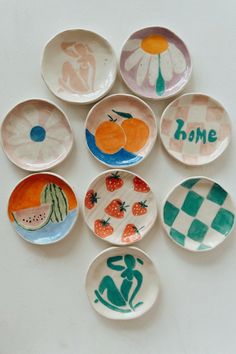 six plates with different designs and words on them