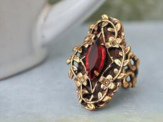 Beautiful Victorian style antiqued brass ring with sparkle ruby red Swarovski glass jewel set in center. All metal parts are brass based and are torch soldered together.    Measurement, Adjustable band that fits U.S size 6 to 10. Dark Victorian, Ring With Ruby, Ruby Red Color, Bijoux Art Nouveau, Pink Swarovski, Fashion Jewelry Sets, Brass Ring, Victorian Jewelry, Pretty Rings