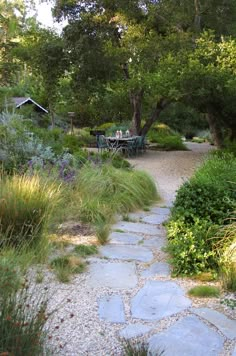 a stone path leads to an outdoor dining area