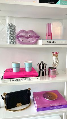 Cb2 bookshelf styling colorful home decor, pink home decor Rhinestone Decor Home, Trendy Shelf Decor, Shelf Decor Room Ideas, Coffee Book Decor, Jonathan Adler Office, College Apartment Coffee Table, Desk Shelves Aesthetic, Book Shelf Decor Ideas Bedroom, Jonathan Adler Style