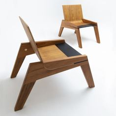 two wooden chairs sitting next to each other