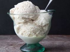 a glass bowl filled with ice cream on top of a table