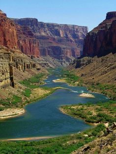 a river running through a canyon surrounded by mountains