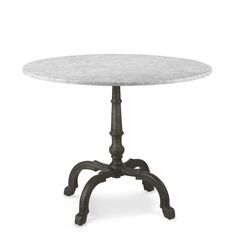 a white marble top table with an iron frame base and cast iron legs, on a white background