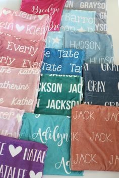 many different colored towels with names on them