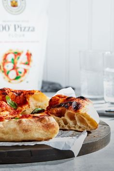 a pizza sitting on top of a wooden cutting board