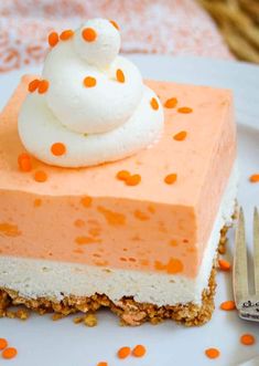 a piece of cheesecake on a plate with orange confetti