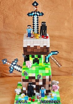 a cake made to look like a minecraft house with lots of items on it