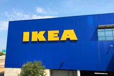 an ikea store is shown with blue and yellow letters on the building's side