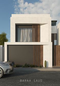 a car is parked in front of a modern house with wood and white sidings