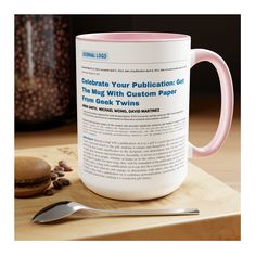 a blue and white coffee mug sitting on top of a cutting board next to a spoon