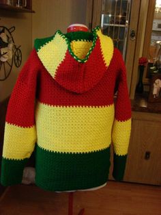 a red, yellow and green sweater on a mannequin