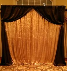 a gold and black stage set up for a wedding or special event with flowers on the floor