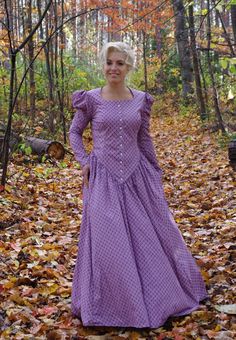 This striking dress has a rounded open neckline, front button closure and leg-o-mutton long sleeves. The waist creates a deep V in the front. This dress also features our three-paneled full skirt with pockets. Hand wash or machine wash and dry gently. 100% sturdy cotton. The model is wearing boots and a crinoline, which are priced separately. Designed and made proudly by Recollections in America! The following are approximate finished measurements and include room for ease of movement.  BustWais Fitted Dresses With Bishop Sleeves And Buttons, Long Sleeve Dress With Gathered Sleeves For Gatherings, Classic Fitted Long Sleeve Prairie Dress, Fitted Prairie Dress With Gathered Sleeves, Fitted Long Sleeve Prairie Dress With Buttons, Long Sleeve Prairie Dress For Daywear, Fitted Peasant Prairie Dress, Daywear Long Sleeve Prairie Dress With Gathered Sleeves, Daywear Prairie Dress With Gathered Sleeves