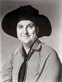 black and white photograph of a man wearing a cowboy hat