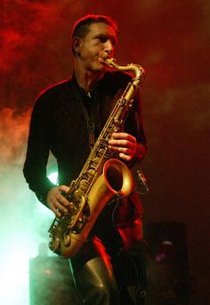 a man is playing the saxophone on stage