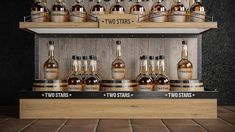 several bottles of whiskey are on display in a wooden case with two stars signs above them