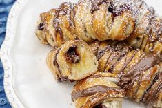 chocolate covered croissants on a white plate