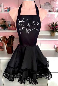 Vintage inspired ruffled black apron with cute white graphic that says “just a touch of arsenic”  has a pinup gothic vibe. One size. Gothabilly Outfits, Gothic Apron, Anime Fireworks, Housewife Apron, Apron Outfit, Gothic Pinup, Pinup Apron, Ruffled Apron, 50s Housewife