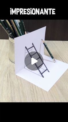 a card with an image of a ladder and pencils in it on top of a table