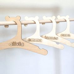 wooden clothes hangers with name and shape for children's clothing hanging on a rail