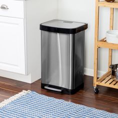 a stainless steel trash can in a kitchen