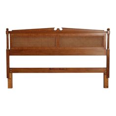 a wooden bed frame with rattan headboard and foot board