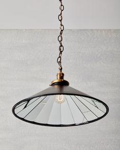 a light hanging from a chain on a wall